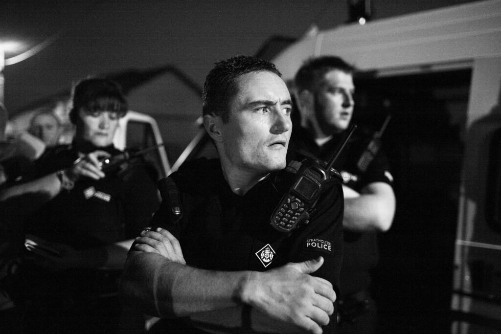 Members of a police public order unit on patrol in Glasgow's East End, Scotland