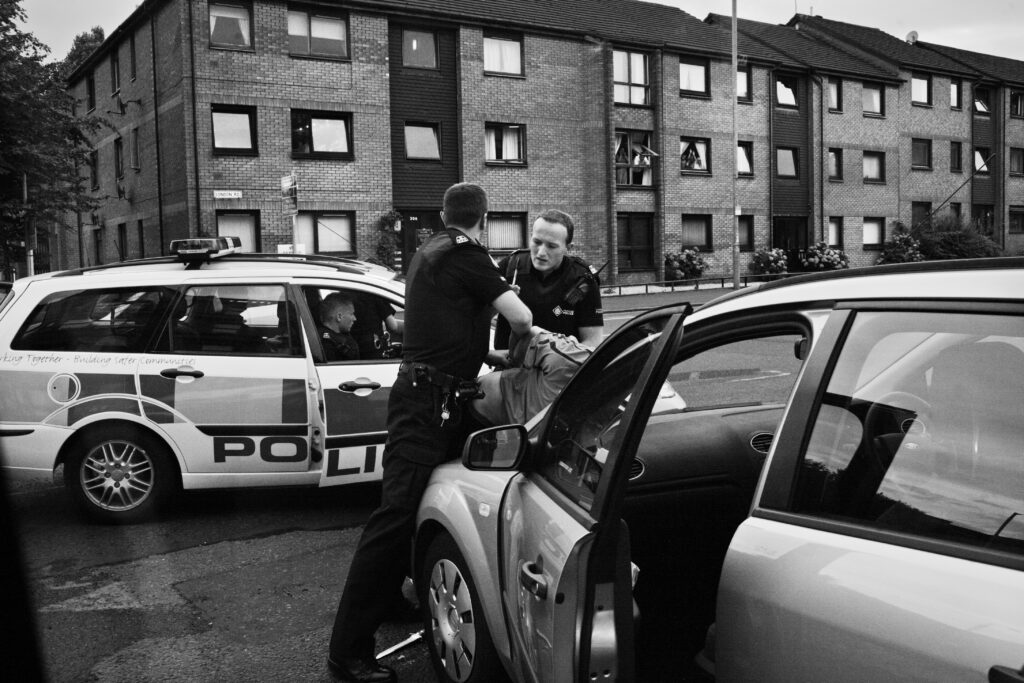 Police arrest a man running from the scene of a violent knife attack as he drops the blade under the wheel of the car.