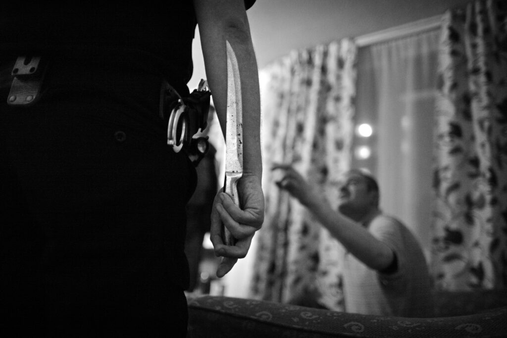 A policeman holds a large knife removed from a suspect in Glasgow Scotland