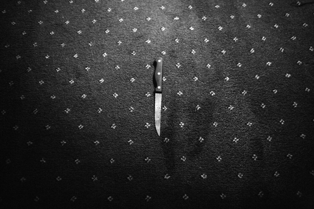 The knife used in a brutal stabbing lies on the living room floor. Glasgow, Scotland